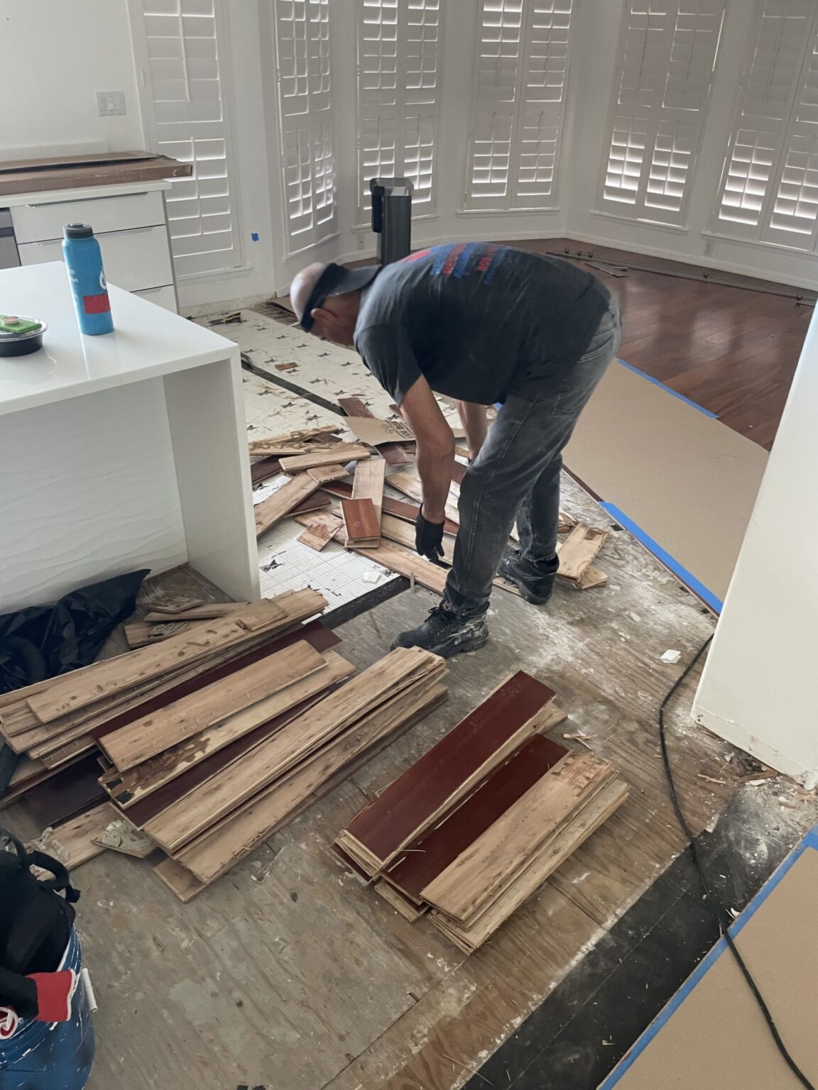 Removing wet flooring so the subfloor can dry.