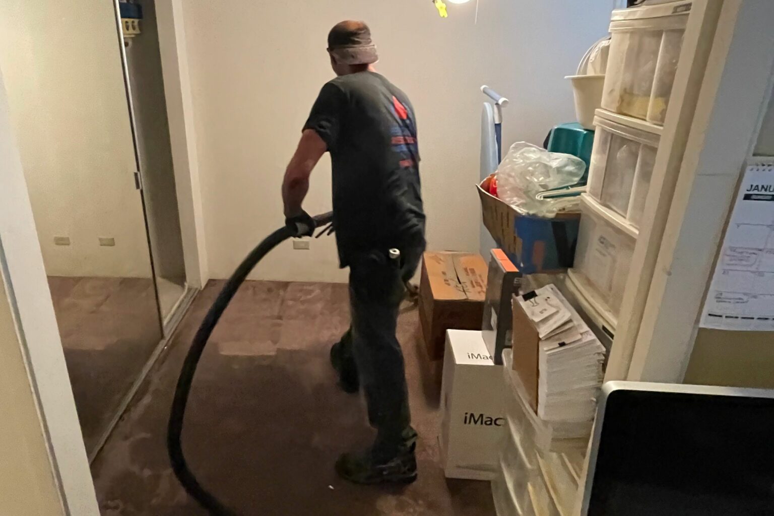 Pulling water out of a flooded room.